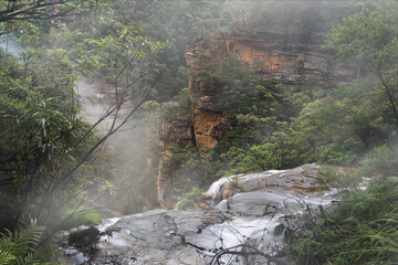 Water fed by the Jamison Creek  flows over the cliff edge at Wentworth Falls for a drop of around...