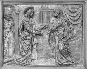 Title: NAPLES, ITALY - APRIL 22, 2023: The bronze relief of Visitiation on the gate of church Basilica dell Incoronata Madre del Buon Consiglio from 20. cent.

