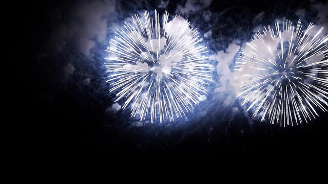 4K. loop seamless of real fireworks background. abstract blur of real golden shining fireworks with bokeh lights in the night sky. glowing fireworks show. New year's eve fireworks celebration