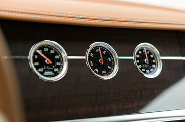expensive mechanical compass, pressure and temperature gauges in the interior of a luxury coupe...