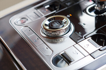 Close up shot of modern central console with navigation, music and other setting buttons in a...