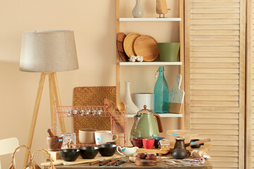 Many different cooking utensils in room. Garage sale