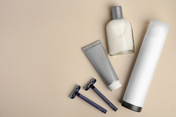 Flat lay composition with shaving accessories for men on beige background. Space for text