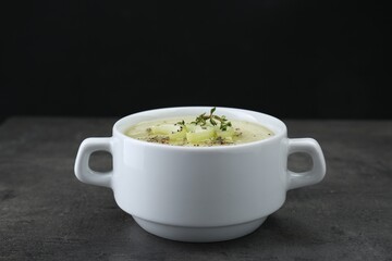 Bowl of delicious celery soup on gray table
