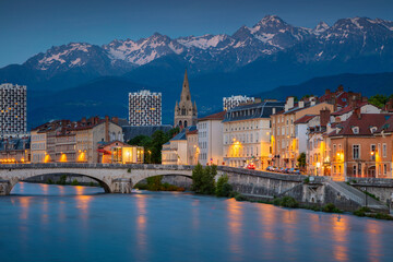 Cityscape image of Grenoble, France during twilight blue hour.
