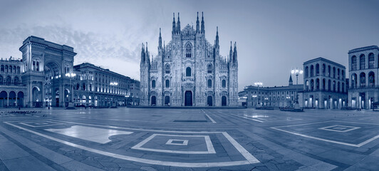 Panoramic cityscape image of Milan, Italy with Milan Cathedral during sunrise.