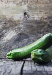 Vegetables background. Fresh green zucchini  on wood in vintage setting