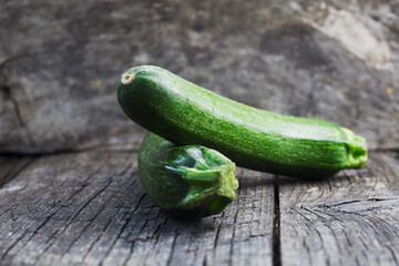 Vegetables background. Fresh green zucchini  on wood in vintage setting