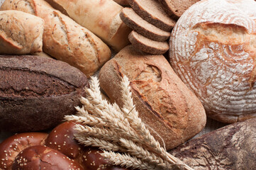 Different tipes of bread with ears of wheat. Food background. Food concept.