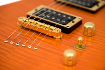 Fototapeta na wymiar Detail of Orange Electric Guitar Body with Strings