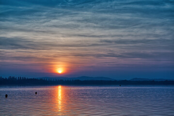 Fototapeta na wymiar great sunset over the lake of Varese in autumn season with amazing cloudy sky