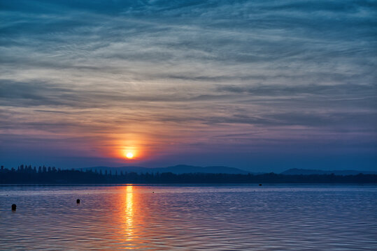 great sunset over the lake of Varese in autumn season with amazing cloudy sky