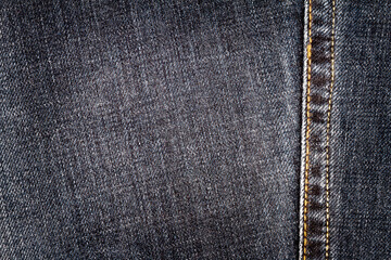 Black jeans texture. Denim jeans texture, denim jeans background with a seam. Jeans fashion design.