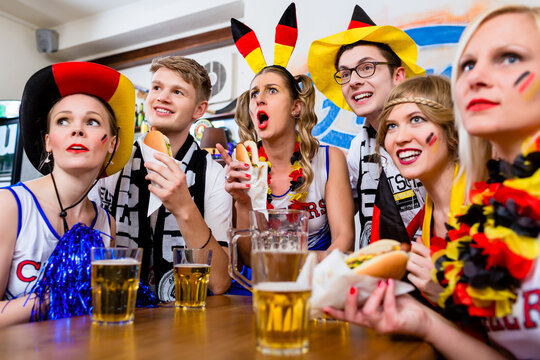 Soccer fans watching a game of the German national team waring all kinds of accessories