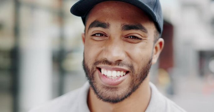 Laughing, face and a man or courier in the city for logistics, ecommerce delivery or happy with a job. Smile, closeup portrait and a sales, retail or service employee with happiness from distribution