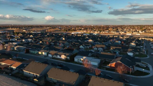 Rising aerial view of homes in the Tri-Cities, part of Washington State's desert landscape.
