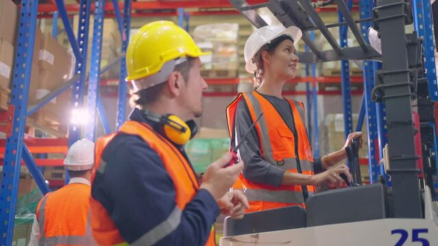 Caucasian man and woman industrial worker work in manufacturing plant.