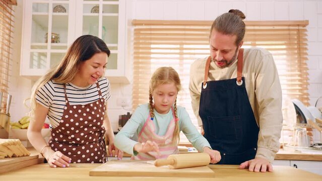 Caucasian attractive couple baking bakery with son in kitchen at home.