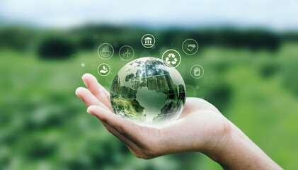 Hand of human holding earth with ESG icon for Environment Social and Governance, World sustainable...