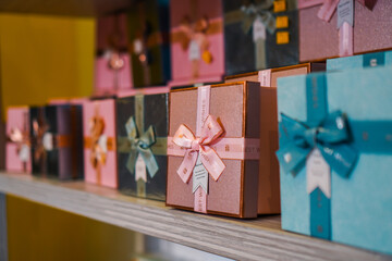 Colorful and patterned gift box stacks arranged on multi-tiered shelves