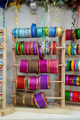 Colorful gift ribbon collection: a range of vibrant options arranged on a store rack