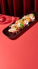 Exquisite Asian appetizer of meat, veggies, mushrooms; displayed against a dark red velvet backdrop, with ample copy space.