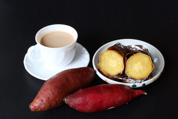 Cup of hot milk Tea with baked sweet potato 