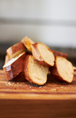 Cooking, food and bakery with bread in kitchen for nutrition, health and diet. Breakfast, cafe and coffee shop with closeup of product on cutting board on table for wheat, grain and wellness