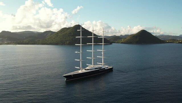 Black Pearl Superyacht in Saint Lucia, Caribbean, in epic Slow Motion. Incredible large sailing yacht, in Rodney Bay, St.Lucia. Famous boat in a tropical bay, drone shot in 4K, 60fps slowed  to 30fps
