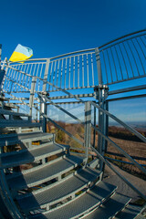 The flag of Ukraine on the observation tower high in the mountains above the Poloniny