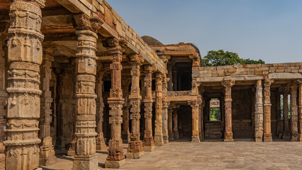 Ruins of the ancient temple complex Qutub Minar. Quwwat-ul-Islam mosque. Gallery with carved...