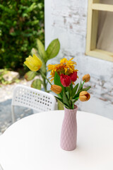 Vase with beautiful flowers on table in outdoor