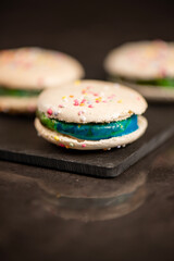 Delicious French sweet vanilla macaron with a velvet rainbow ganache.