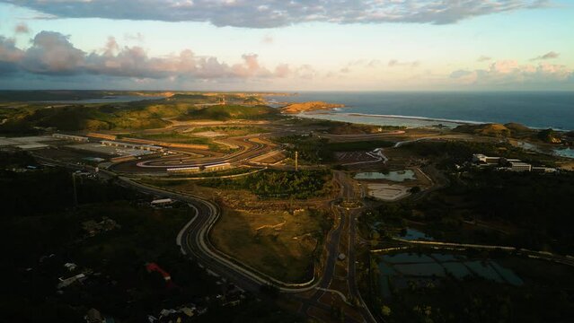 Aerial of the Pertamina Mandalika International Street Circuit track , Kuta, Lombok Island, Indonesia. Drone orbit shot