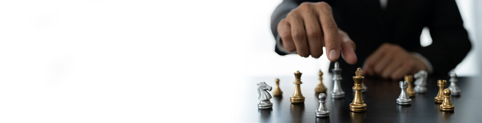 businessman concept, investor holding chess pieces playing chess board game in business competition...