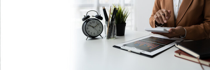 Female entrepreneur, businesswoman using calculator and laptop for calculations record financial work, tax, accounting, income, statistics and business commitments, copy space, panorama, banner