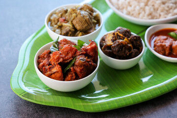 Kerala special food sadhya in banana leaf plate with Chicken fry Duck roast Beef fry Fish curry...