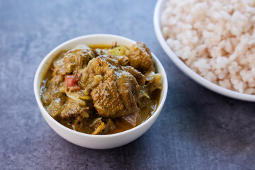 A traditional duck curry roast. Kerala style duck or chicken curry with coconut milk for appam rice. Indian food in black background. 