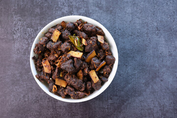 Kerala style beef or Mutton dry fry. delicious spicy Beef fry in clay pot . beef curry for ghee rice, kappa, appam, parotta, puttu, bread and chappathi, beef roast. Indian cuisine .