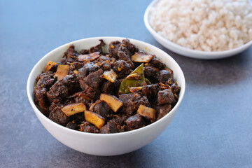 Kerala style beef or Mutton dry fry. delicious spicy Beef fry in clay pot . beef curry for ghee rice, kappa, appam, parotta, puttu, bread and chappathi, beef roast. Indian cuisine .
