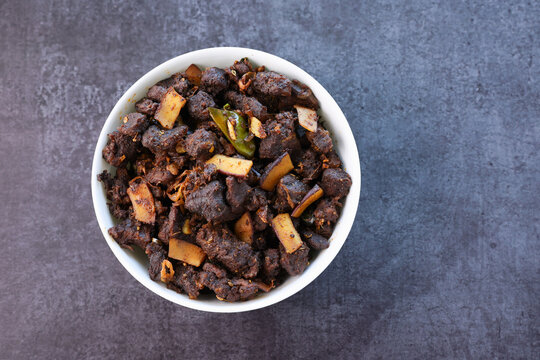 Kerala style beef or Mutton dry fry. delicious spicy Beef fry in clay pot . beef curry for ghee rice, kappa, appam, parotta, puttu, bread and chappathi, beef roast. Indian cuisine .