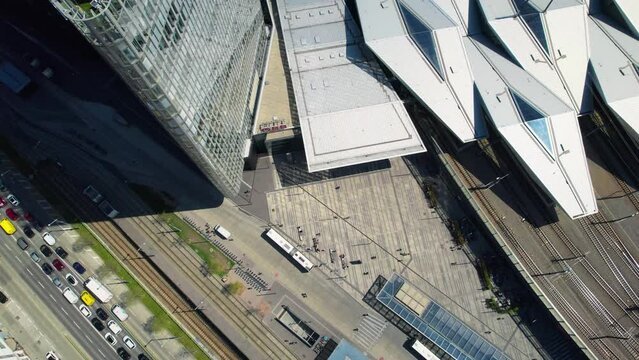 Vienna train station surrounded by skyscrapers, tilt up reveal cityscape, aerial