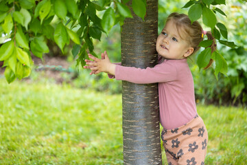 toddler hugs tree, kids love nature, summer outdoor activity