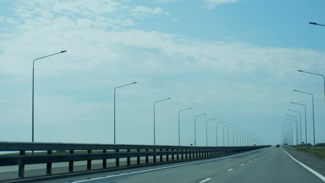 Straight endless road. Smooth asphalt with Mirage in horizon. Powerful chipper and hundreds of lighting poles.