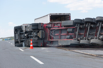 An overloaded and fast truck (TIR) overturned on an interurban road 