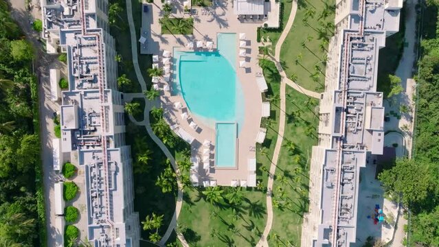 Aerial top down shot of luxury The Westin Puntacana Resort Club with private sandy beach to the Caribbean sea in sunlight - establishing shot 