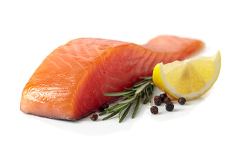 Salmon piece with rosemary, lemon, and peppercorn isolated on a white background.