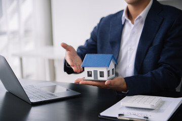 Real estate broker agent presenting to customer to decision making sign insurance form agreement, buy and sell home model, concerning mortgage loan offer