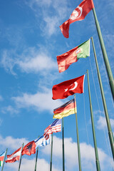 Tunisia, Azerbaijan, Austria, Albania, Germany, USA, Turkey, Portugal and Argentina flags on sky