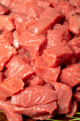 Raw beef meat chopped in cubes. Close-up diced beef or lamb